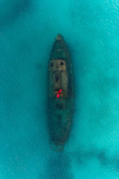 Drone shot directly above a red kayak floating above a shipwreck, Carlisle Bay, Barbados