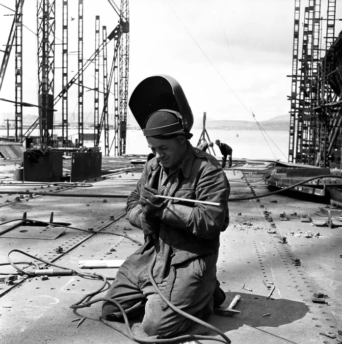 Framed Print : Dry Dock. 17th July 1954: A welder gets to work at a shipyard on the River Framed Print : Dry Dock. 17th July 1954: A welder gets to work at a shipyard on the River