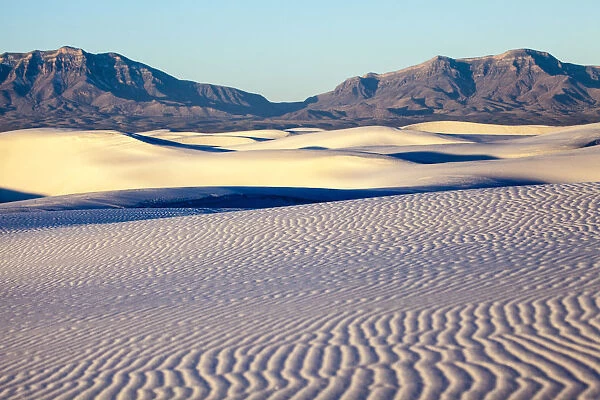 Dunes of White Sands National Monument with rocky mountains in background, New Mexico, USA