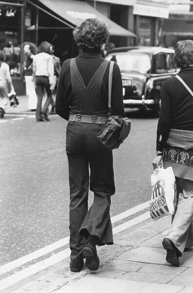 Dungaree Flares. 13th June 1973: A model wearing flared dungarees