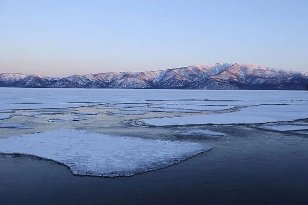 Early morning mood on the frozen Lake Kussharo with ice floes in the front, Akan-Nationalpark, Kawayu Onsen, Hokkaido, Japan