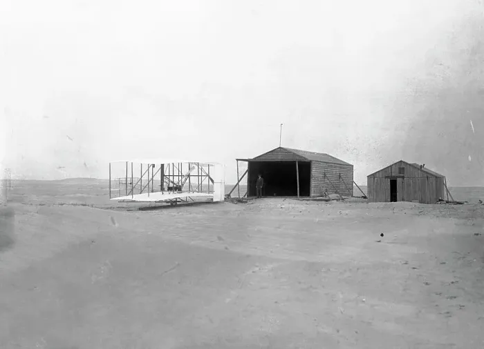Framed Print : Early Wright Brothers Airplane Parked Near Buildings Framed Print : Early Wright Brothers Airplane Parked Near Buildings