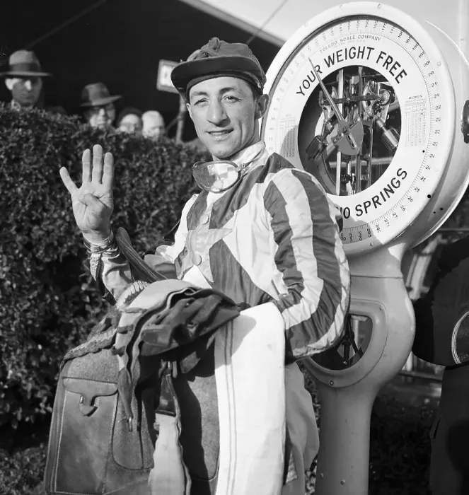 Framed Print : Eddie Arcaro Holding Up Four Fingers at Weigh In Framed Print : Eddie Arcaro Holding Up Four Fingers at Weigh In