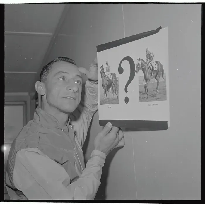Framed Print : Eddie Arcaro Holding Up Pictures of Horse Choices Framed Print : Eddie Arcaro Holding Up Pictures of Horse Choices
