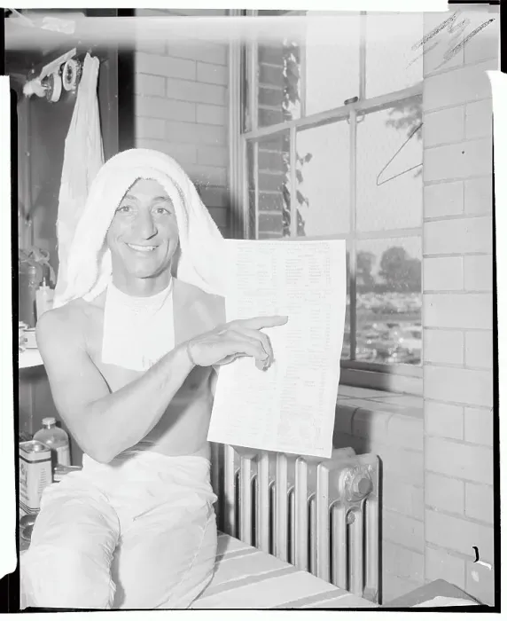 Framed Print : Eddie Arcaro Holding Race List Framed Print : Eddie Arcaro Holding Race List