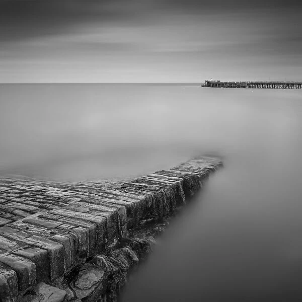 On The Edge. Stone Jetty leading out towards Swanage