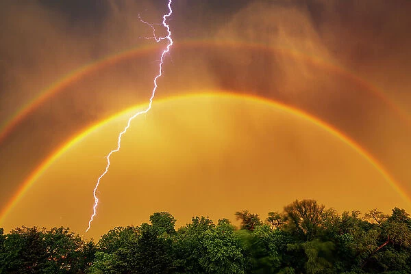 Edmond lightning with a double rainbow, Oklahoma. USA