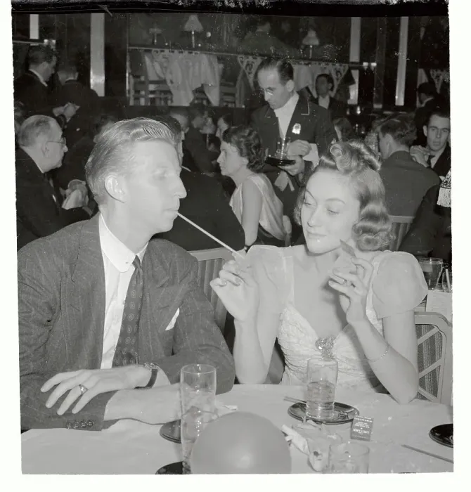 Framed Print : Edythe Wright Lighting Cigarette for Don Budge