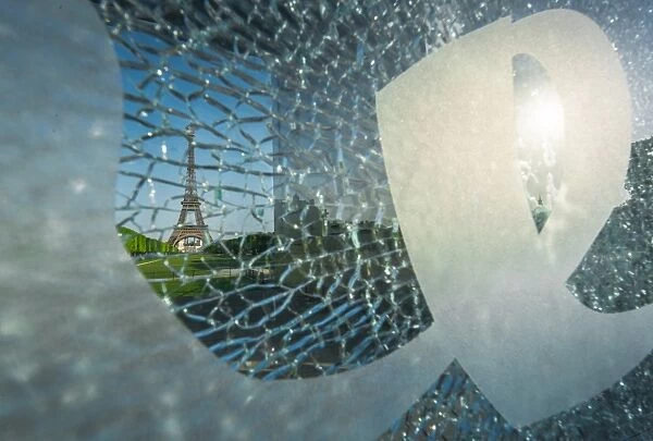 Eiffel tower through broken glass