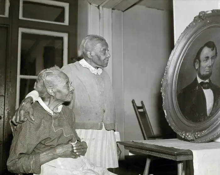 Framed Print : Two Elderly Black Women Look At Portrait Framed Print : Two Elderly Black Women Look At Portrait
