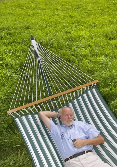 Framed Print : Elderly gentleman lying in a hammock and listening to music Framed Print : Elderly gentleman lying in a hammock and listening to music