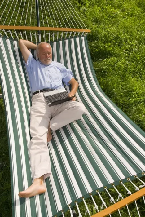 Framed Print : Elderly gentleman lying in a hammock with a netbook Framed Print : Elderly gentleman lying in a hammock with a netbook