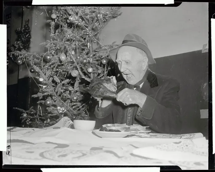 Framed Print : Elderly Man Eating Large Piece of Poultry at Table Framed Print : Elderly Man Eating Large Piece of Poultry at Table
