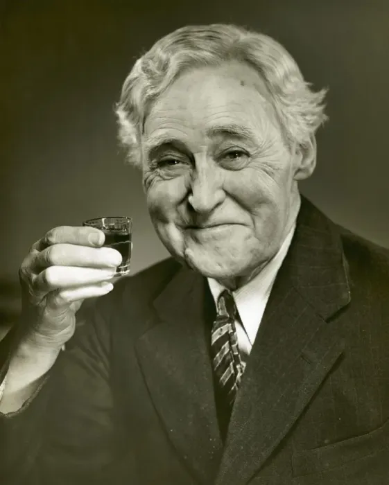 Framed Print : Elderly man raising glass of whiskey