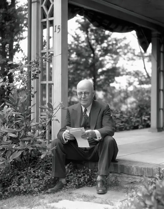 Framed Print : Elderly man, smiling, sitting on front porch step, reading letter
