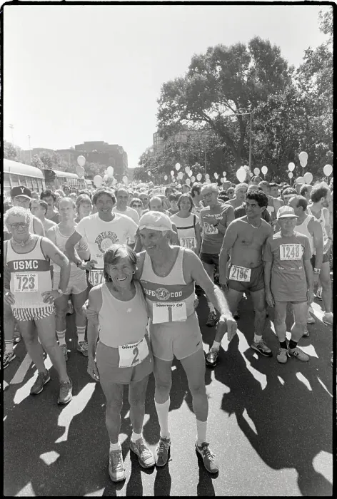 Framed Print : Elderly Marathon Runners Hug & Pose Framed Print : Elderly Marathon Runners Hug & Pose