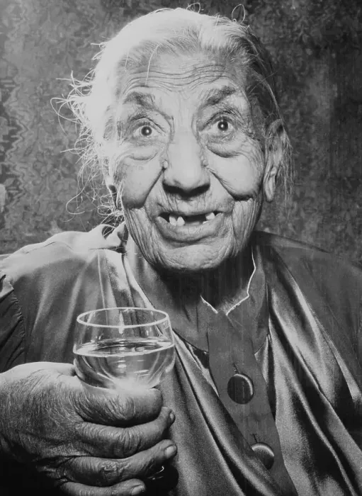 Framed Print : Elderly Woman Holding Glass of Liquor Framed Print : Elderly Woman Holding Glass of Liquor