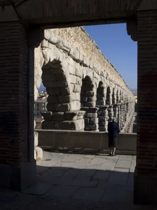 Framed Print : Elderly woman looking at the aqueduct of Segovia Framed Print : Elderly woman looking at the aqueduct of Segovia