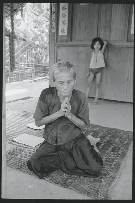 Framed Print : Elderly Woman Praying in Front of Home Framed Print : Elderly Woman Praying in Front of Home
