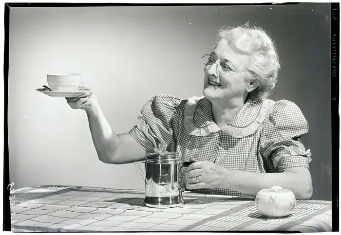 Framed Print : Elderly Woman Serving Coffee Framed Print : Elderly Woman Serving Coffee