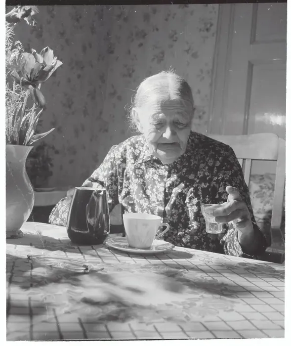 Framed Print : Elderly Woman at Table with Schnapps Liquor Framed Print : Elderly Woman at Table with Schnapps Liquor
