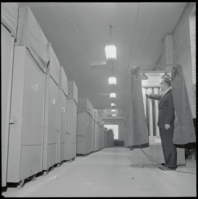Framed Print : Election Official Checking Voting Machinery Inside Booth Framed Print : Election Official Checking Voting Machinery Inside Booth
