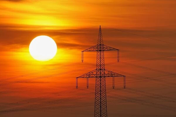 Electric power transmission lines, electricity pylon, with the setting sun, Beinstein near Stuttgart, Baden-Wuerttemberg, Germany, Europe