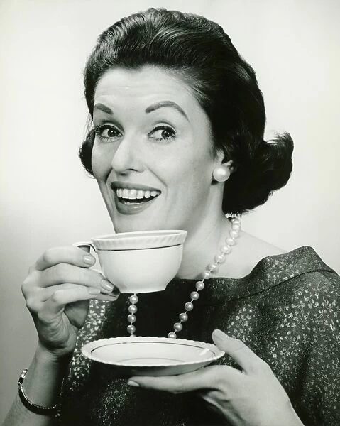 Elegant holding cup and saucer, (B&W), (Portrait)