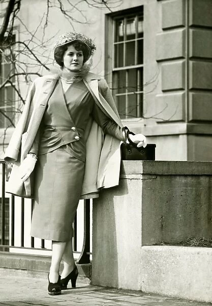 Elegant woman posing on sidewalk, (B&W)