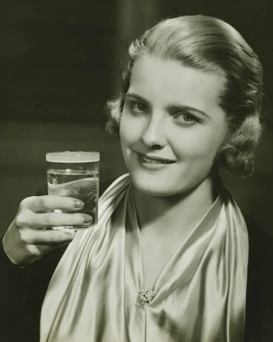 Framed Print : Elegant woman raising glass of water, posing in studio, (B&W), close-up, portrait Framed Print : Elegant woman raising glass of water, posing in studio, (B&W), close-up, portrait