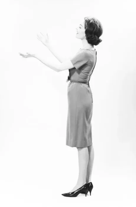 Framed Print : Elegant woman standing in studio, gesturing, (B&W) Framed Print : Elegant woman standing in studio, gesturing, (B&W)