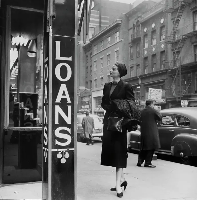Framed Print : Loans. An elegantly-dressed woman looking in a shop window which advertises loans Framed Print : Loans. An elegantly-dressed woman looking in a shop window which advertises loans