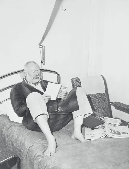 Framed Print : Ernest Hemingway Reading in Bed Framed Print : Ernest Hemingway Reading in Bed