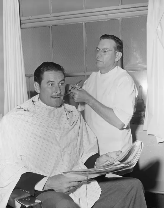 Framed Print : Errol Flynn Getting Haircut Framed Print : Errol Flynn Getting Haircut