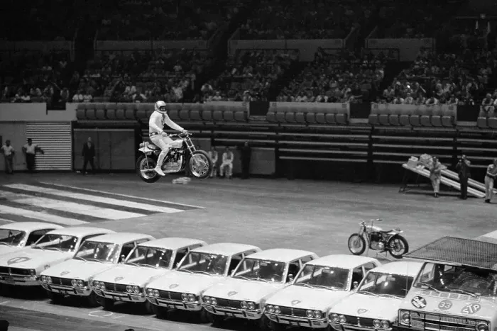 Framed Print : Evel Knievel Jumping Motorcycle over Cars Framed Print : Evel Knievel Jumping Motorcycle over Cars
