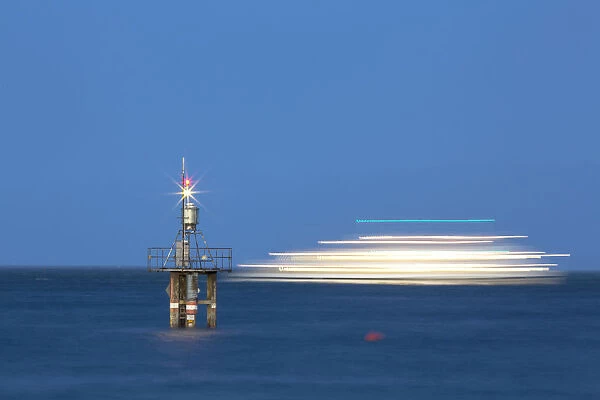 Evening mood with a with moving ship at the Hoernle Lighthouse, Lake Constance, Konstanz, Baden-Wurttemberg, Germany