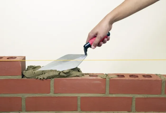 Framed Print : Evening off mortar on bricks with a trowel Framed Print : Evening off mortar on bricks with a trowel