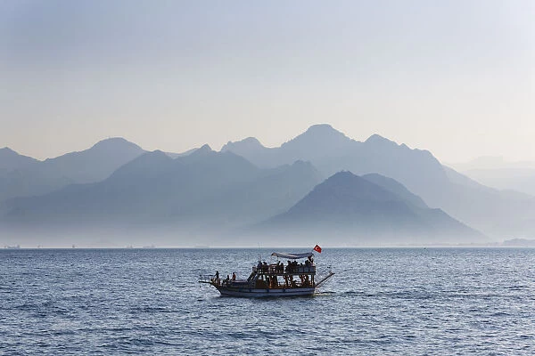 Excursion boat on the sea, in front of the Taurus Mountains, Lycian Taurus, Antalya, Turkish Riviera, Province of Antalya, Mediterranean Region, Turkey