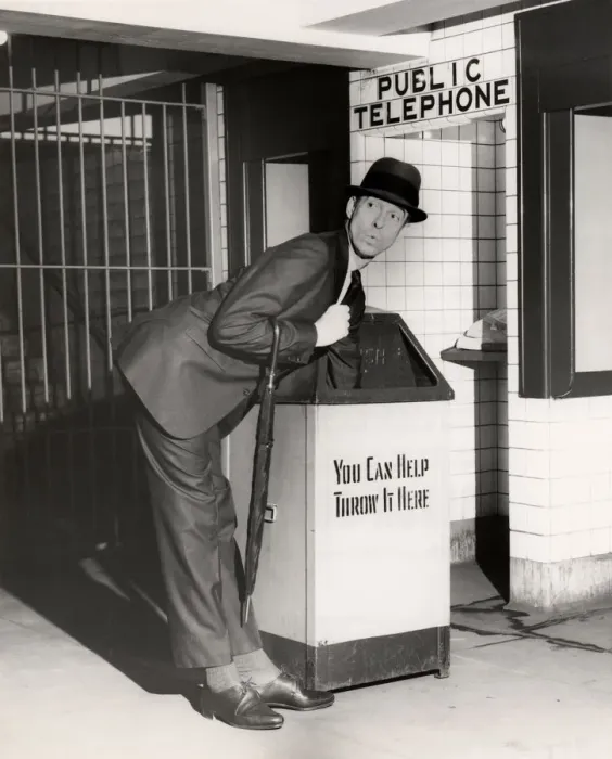Framed Print : Executive with arm in public trash receptacle