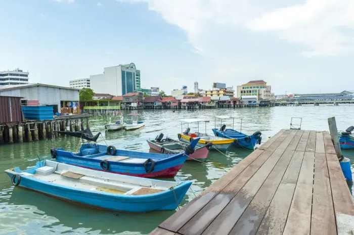 Framed Print : An exotic timber jetty with wooden sampan boats