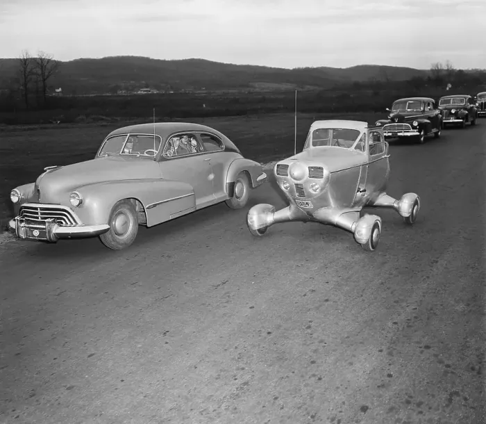 Framed Print : Experimental Vehicle Passing Cars on Highway Framed Print : Experimental Vehicle Passing Cars on Highway