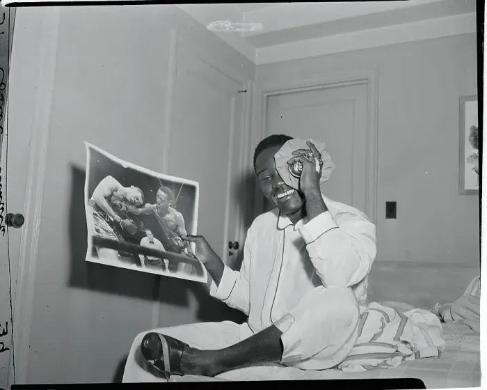 Framed Print : Ezzard Charles Holding a Photograph Framed Print : Ezzard Charles Holding a Photograph
