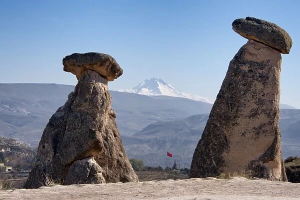 Fairy chimneys in Urgup with Mount Erciyes in the background, Cappadocia, Turkey