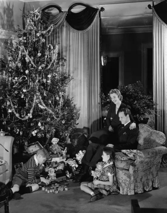 Framed Print : Family with two children (6-9) sitting at Christmas tree, (B&W) Framed Print : Family with two children (6-9) sitting at Christmas tree, (B&W)
