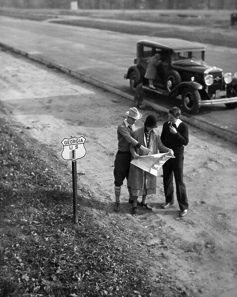 Family consulting road map on Georgia highway, USA (B&W)