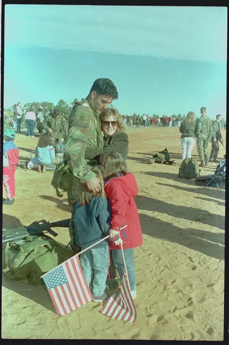 Framed Print : Family Embracing Paratrooper