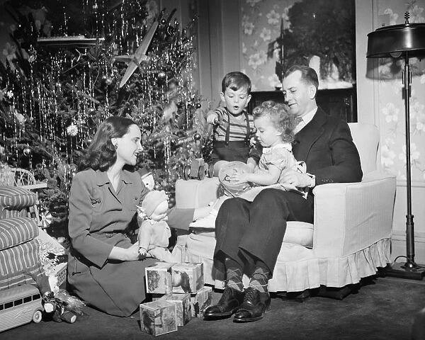 Family opening Christmas presents, children (2-3) (4-5), (B&W)