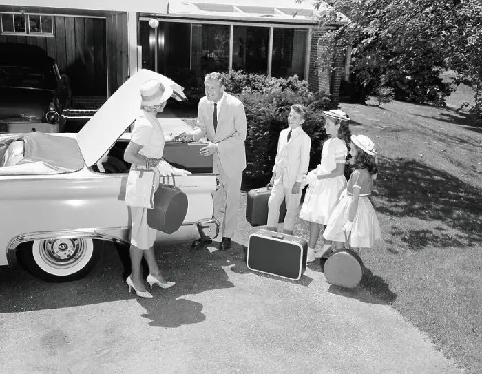 Framed Print : Family packing suitcases in trunk of car parked on driveway, preparing for vacation Framed Print : Family packing suitcases in trunk of car parked on driveway, preparing for vacation