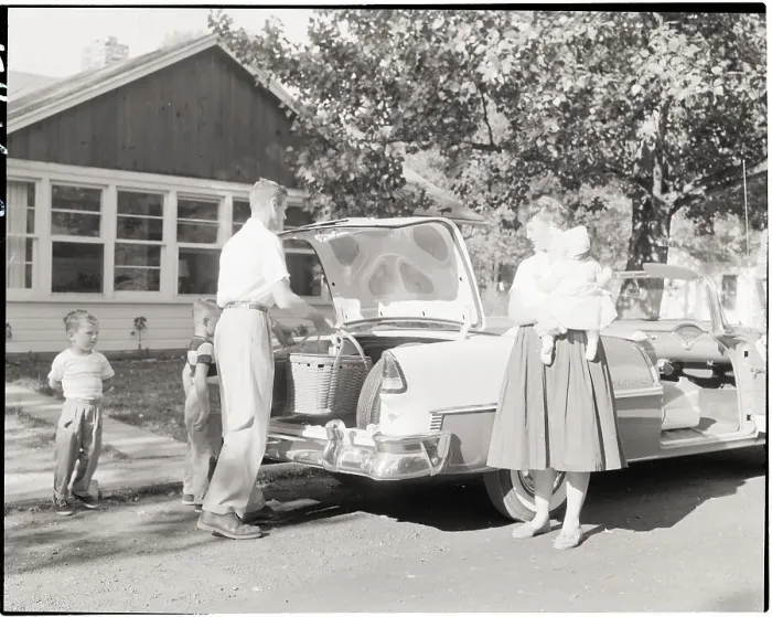 Framed Print : Family Placing Picnic Basket in Car Framed Print : Family Placing Picnic Basket in Car
