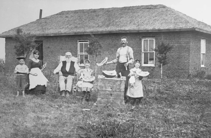 Framed Print : Family Relaxing Outside Their Farm House Framed Print : Family Relaxing Outside Their Farm House